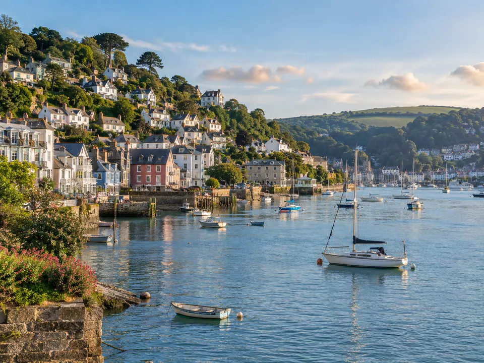 Dartmouth harbour with hillside houses and boats on the River Dart